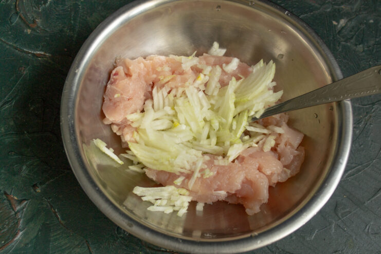 Mixing minced onion into ground meat for the lahmacun filling