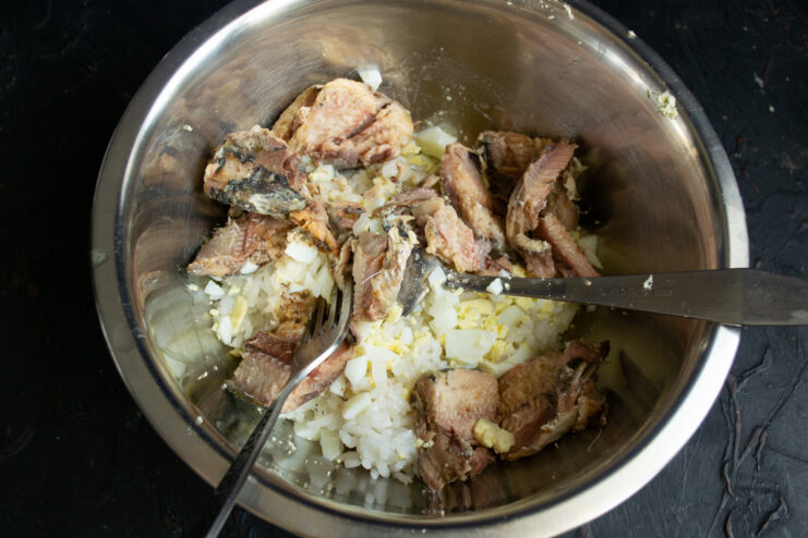 Adding the sardines Pieces of canned sardines placed over the rice and egg mixture