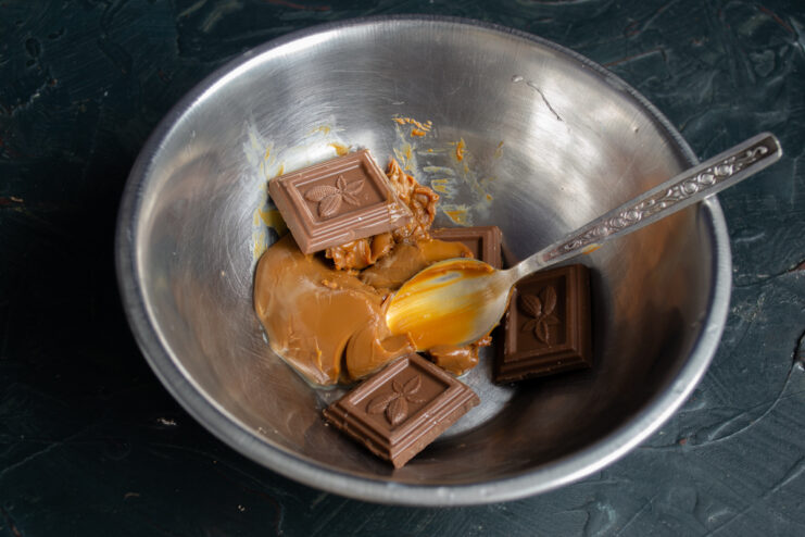Combining ingredients for the chocolate buttercream Chocolate pieces, caramelized condensed milk, and butter in a bowl