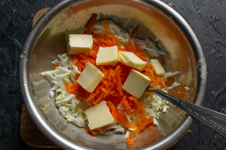 Pieces of butter added to the bowl with the other filling ingredients.