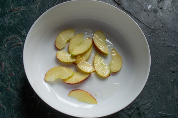 Apple Cushion Layer Sliced apples arranged on the bottom of a baking dish