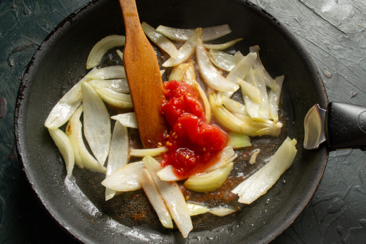 Onions and tomatoes Onions and tomatoes sautéing in a skillet