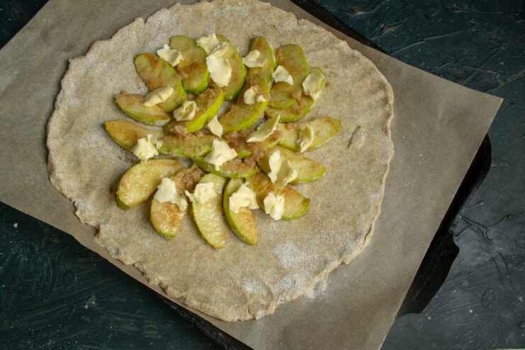Adding Butter to Filling Small pieces of butter dotted over apple filling