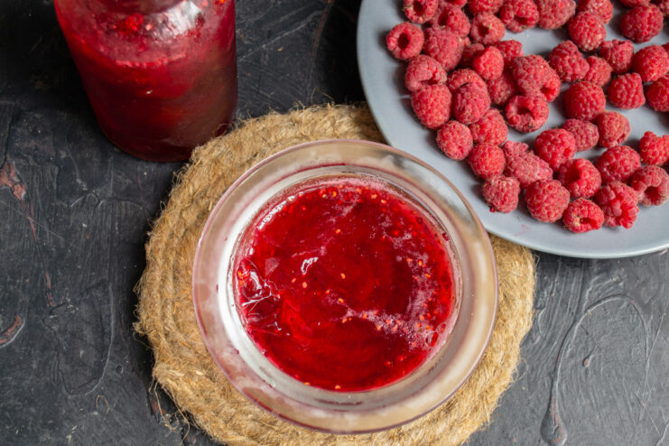 Making the Raspberry Base Bowl of bright raspberry juice next to fresh berries