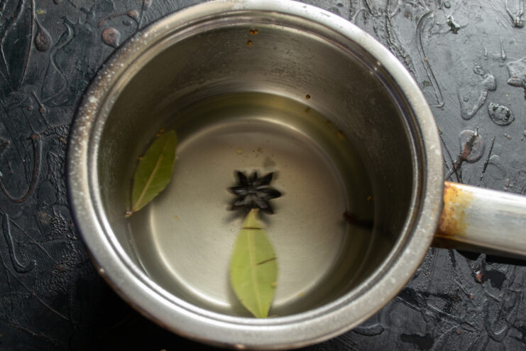 Preparing the marinade Simmering marinade with bay leaves and star anise in a saucepan