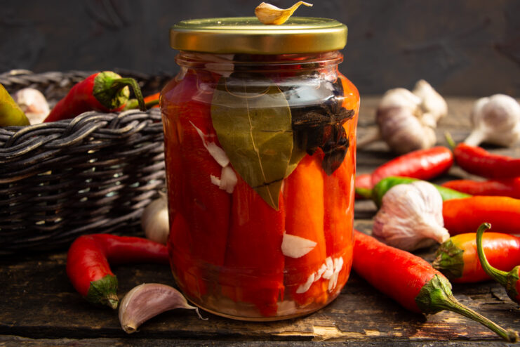 Jar of pickled chili peppers with honey and vinegar