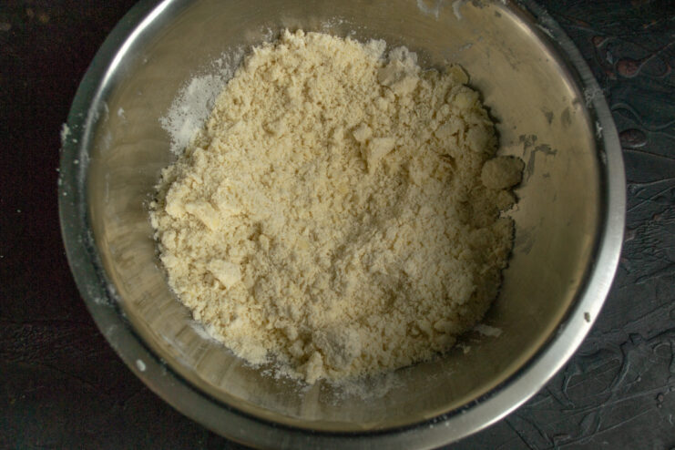 Rubbing butter and flour Buttery flour crumb mixture for the apple pie crust