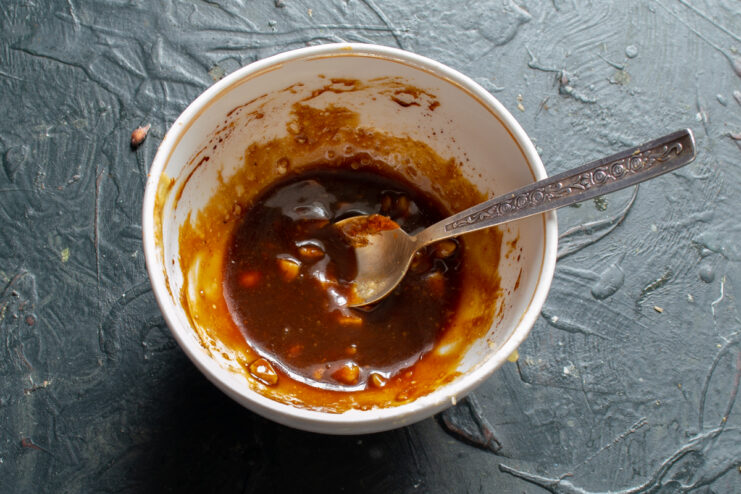 Preparing The Glaze Honey mustard glaze with chopped nuts in a bowl
