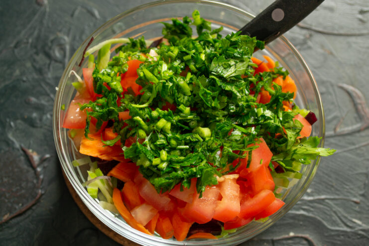 Adding Fresh Herbs Finely chopped fresh parsley sprinkled over vegetable salad