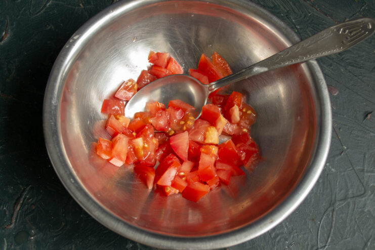 Dicing tomatoes for salsa Finely diced red tomatoes in a mixing bowl