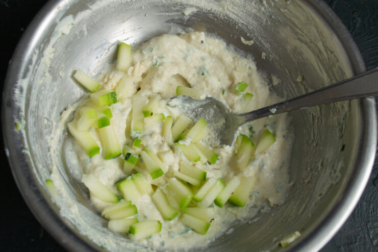 Finely diced zucchini pieces folded into the batter