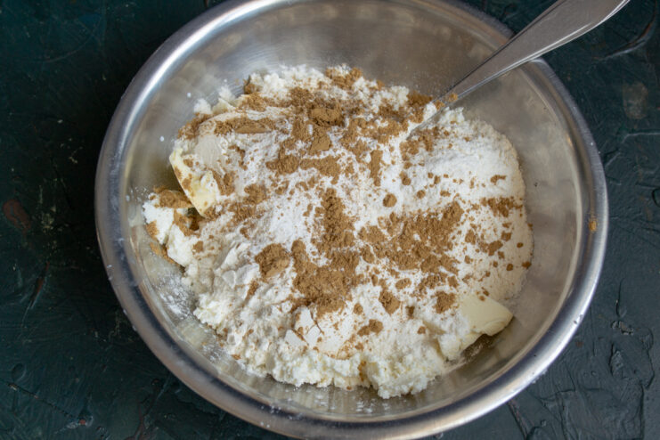 Ground cinnamon sprinkled over the bun dough