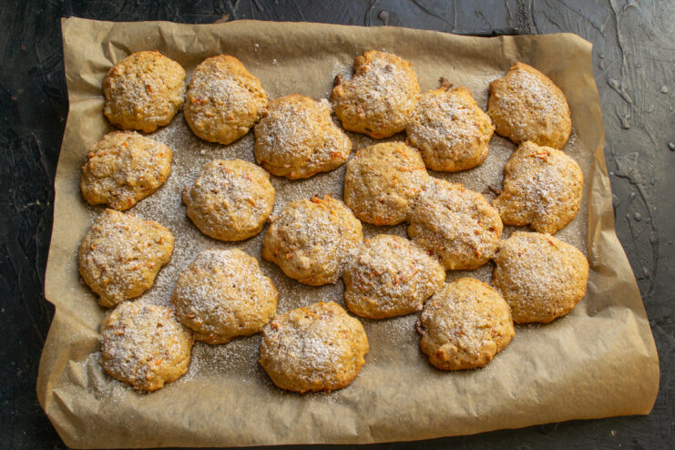 Powdered sugar decoration Carrot cookies dusted with powdered sugar on parchment paper