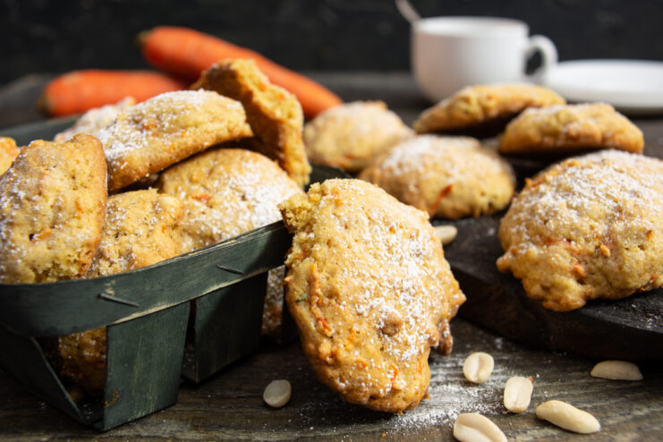Freshly baked carrot and peanut cookies dusted with powdered sugar in a basket