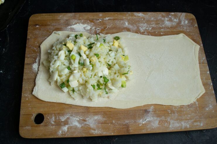 Savory filling spread onto half of a rolled pastry sheet
