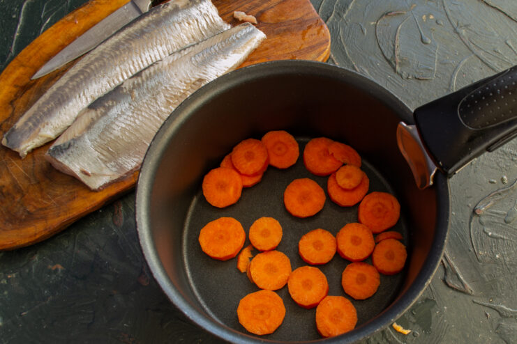 Blanching carrots Sliced carrots in a saucepan next to the fish
