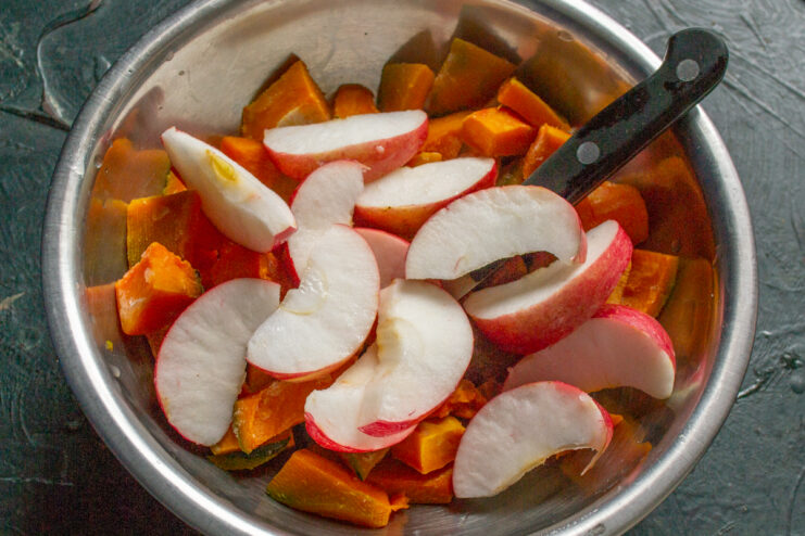 Chopping pumpkin and apples Diced pumpkin and apple slices in a glass bowl