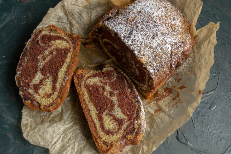 Slicing The Cake Sliced pieces of Zebra cake with poppy seeds resting on paper