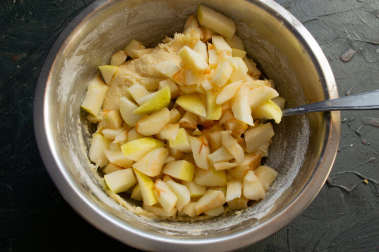 Adding fresh apple slices Sliced apples being folded into the scone dough