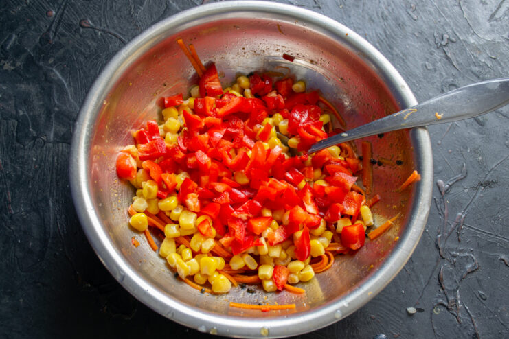Adding Bell Pepper Diced red bell pepper added to the salad bowl