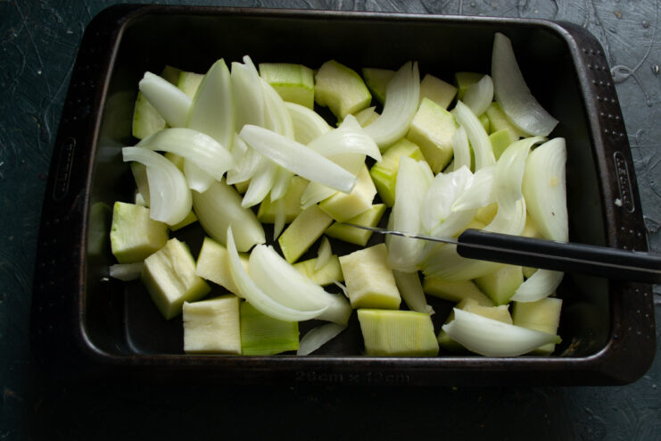 Adding chopped onions Thick onion wedges placed on top of diced zucchini