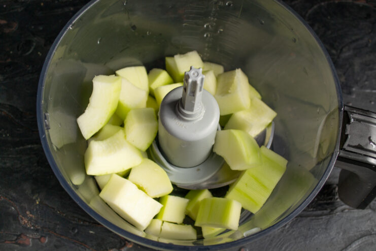 Diced zucchini pieces placed inside a blender pitcher
