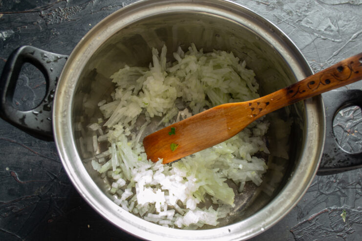 Sweating the onion Diced onions sweating in a pot with a small amount of chicken broth