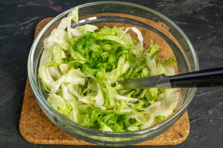 Prepping the lettuce Chopped Iceberg lettuce in a glass bowl