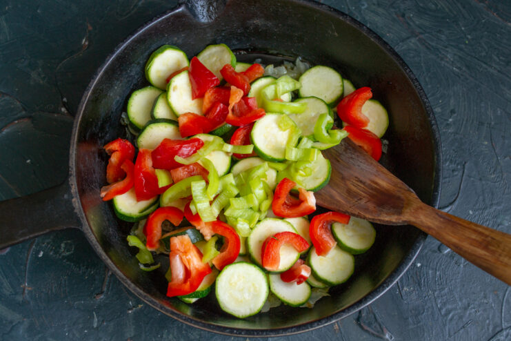Adding the Chili Pepper Minced green chili pepper added to the vegetable mixture in the skillet