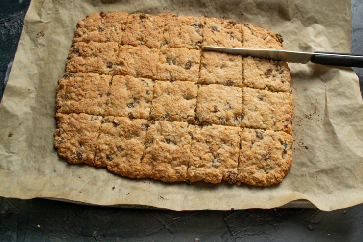 Cutting into diamonds or squares Slicing the hot baked cookie slab into squares with a knife