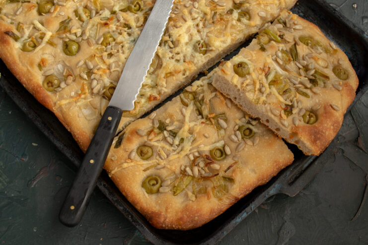 Slicing the focaccia Slicing the freshly baked focaccia with a knife