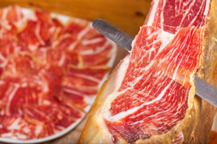 Spanish jamon iberico de bellota Thinly sliced Spanish jamon iberico showing rich meat and marbled fat