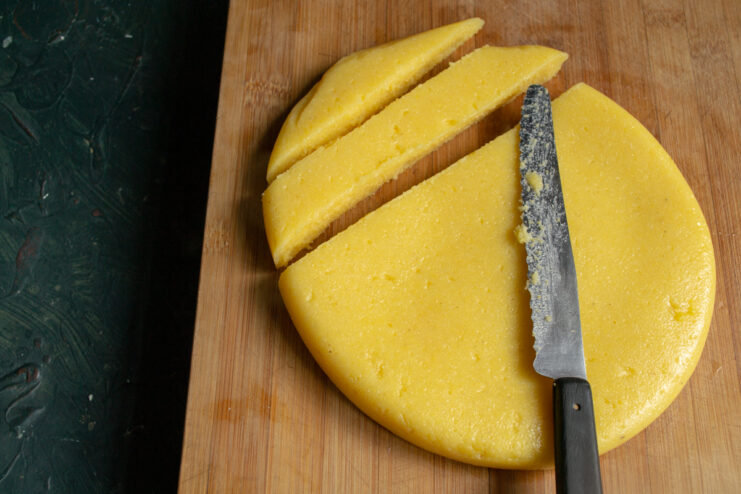 Slicing The Polenta Slicing a block of set polenta into strips