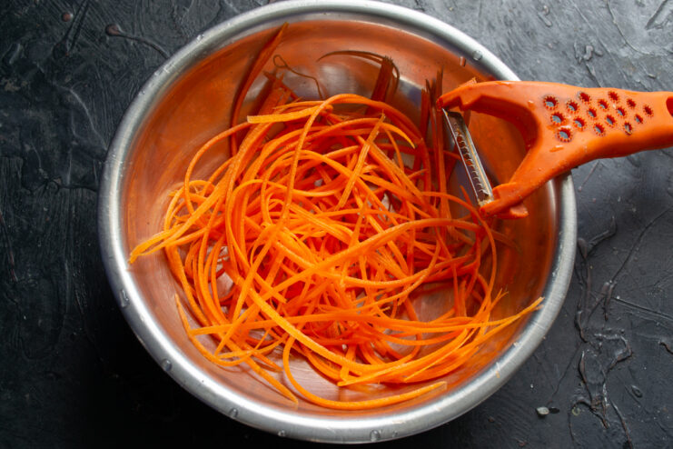 Grating The Carrots Julienned carrots in a metal prep bowl
