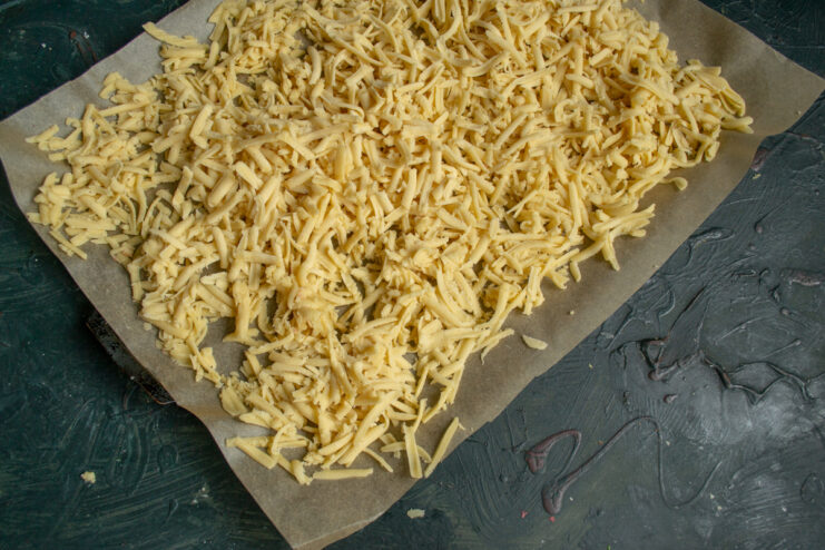 Dough before baking Grated dough spread out evenly on a metal baking sheet
