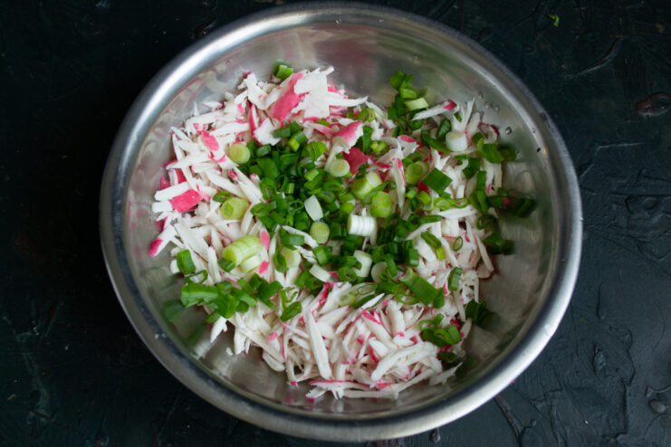 Adding the greens Grated crab sticks mixed with chopped green onions