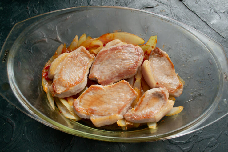 Meat layer Seared pork layered over vegetables in a baking dish