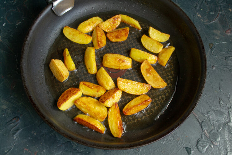 Frying potatoes to a golden crust Frying potato wedges in a hot skillet