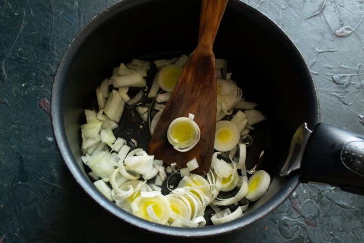 Sautéing the onions Sautéing chopped onions and leeks in a heavy-bottomed pot