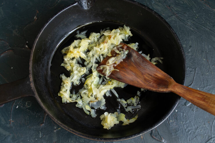 Sautéing the Onions Finely chopped onions sautéing in a pan with butter and oil