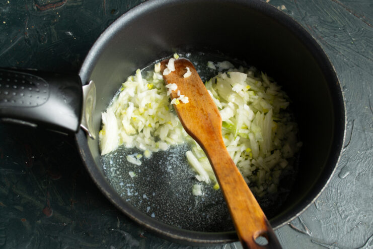 Sauteing onions Sauteing finely chopped onions in melted butter inside a heavy-bottomed pot