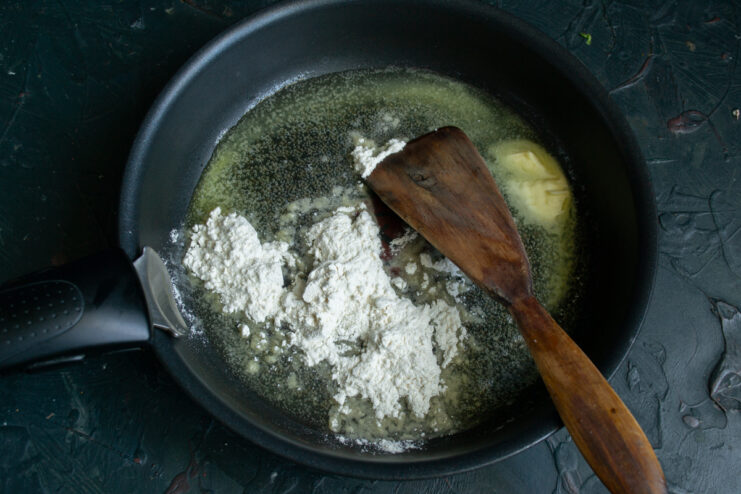 Making the roux Toasting flour in a skillet with melted butter