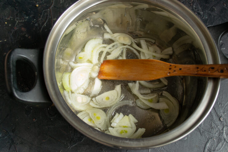 Sauteing onions for the soup Sautéing sliced yellow onions in a pot with melted butter