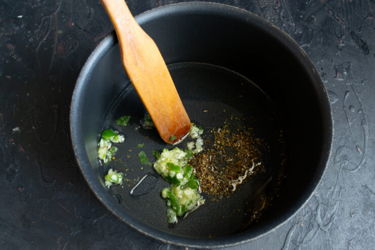 Toasting spices with chili and garlic in a heavy soup pot
