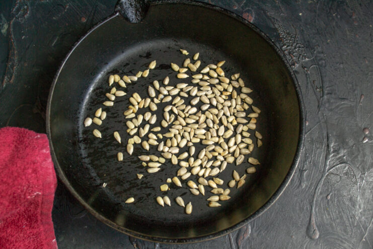Shelled sunflower seeds in a black skillet