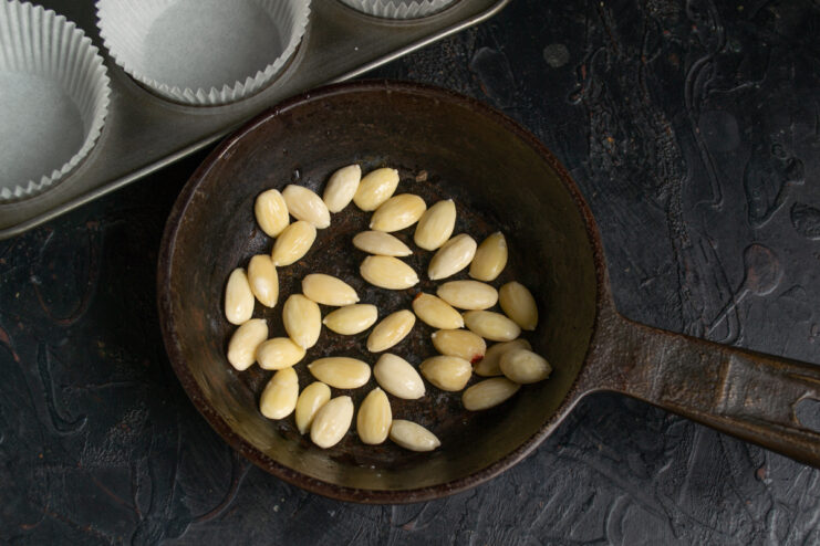 Peeled almonds being toasted in a dry skillet