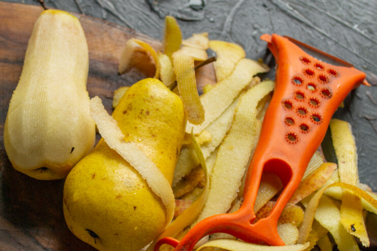 Preparing Pears Peeling whole fresh pears with a small paring knife