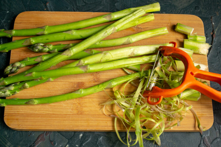 Prepping The Asparagus Peeling asparagus stems with a vegetable peeler