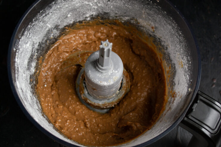 Finished nut paste Smooth caramel-colored paste inside a blender bowl.