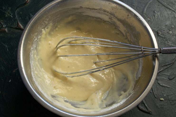 Smooth lump-free batter Smooth and thick fritter batter in a mixing bowl.